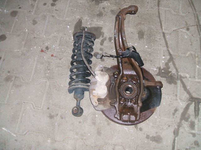 Nissan - Navara - Pick-up - 4 drzwi - (2005 - 2010) - Zawieszenie / Amortyzator przedni lewy